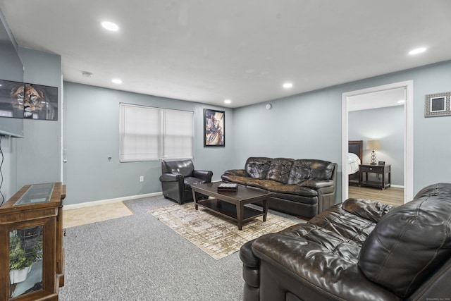 carpeted living area featuring baseboards and recessed lighting