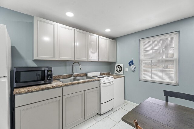 kitchen with light tile patterned floors, recessed lighting, white cabinets, a sink, and white appliances