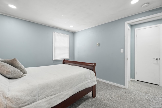 bedroom featuring recessed lighting, light colored carpet, and baseboards