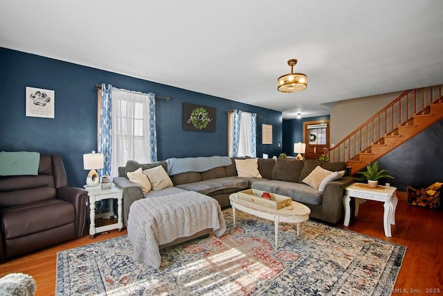 living area featuring stairway and wood finished floors