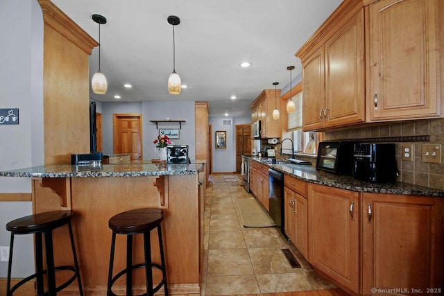 kitchen featuring dishwasher, tasteful backsplash, dark stone countertops, and pendant lighting