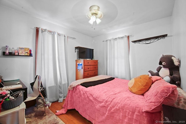 bedroom featuring ceiling fan and wood finished floors