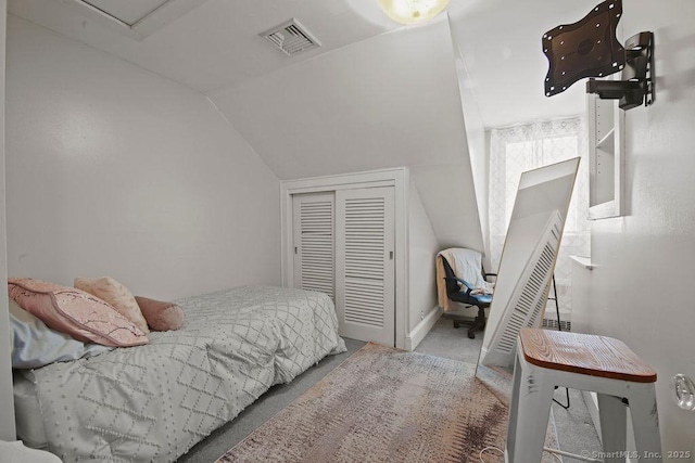 carpeted bedroom with visible vents and vaulted ceiling