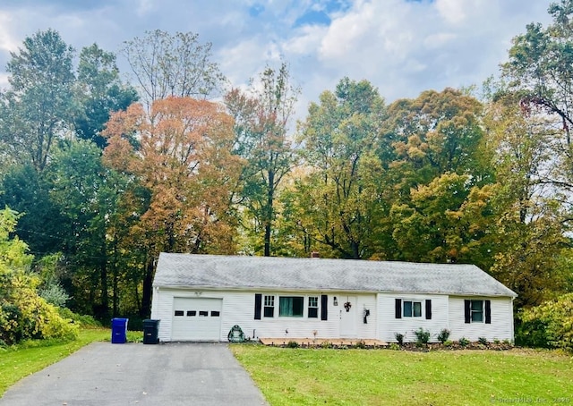 ranch-style house with a garage, aphalt driveway, and a front yard