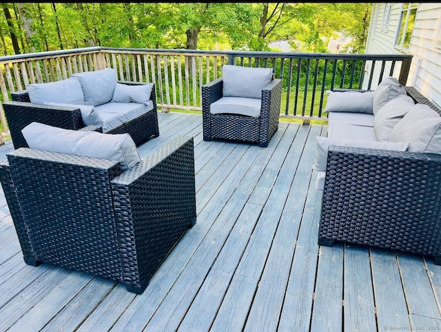 wooden terrace featuring outdoor lounge area