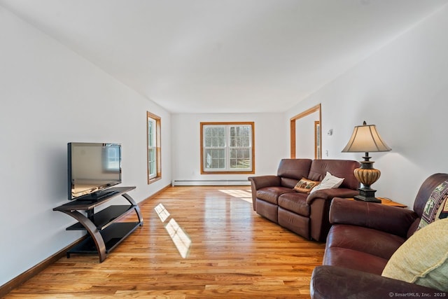 living room featuring light wood-type flooring, baseboards, and a baseboard radiator