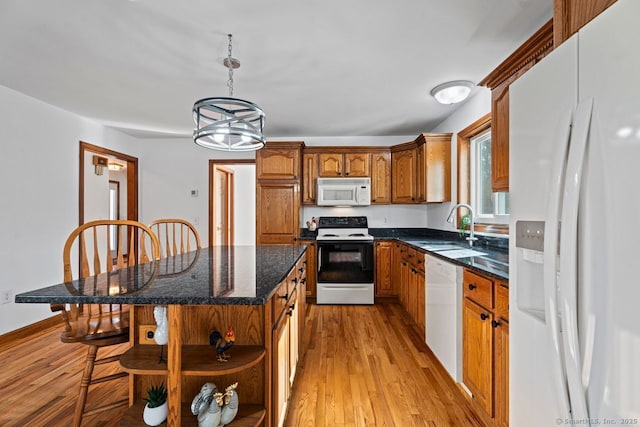 kitchen with white appliances, brown cabinetry, open shelves, a sink, and light wood-type flooring