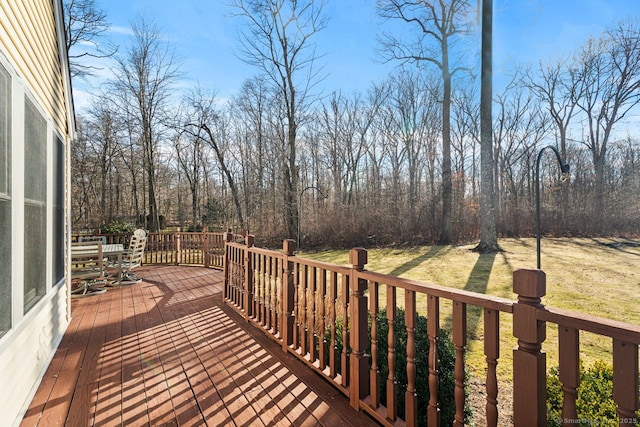 wooden deck featuring a lawn