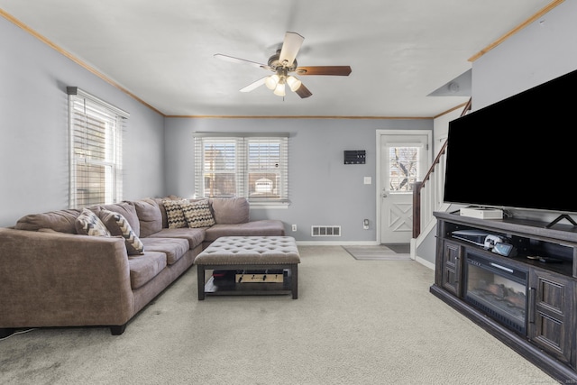 living room with light carpet, baseboards, visible vents, and crown molding