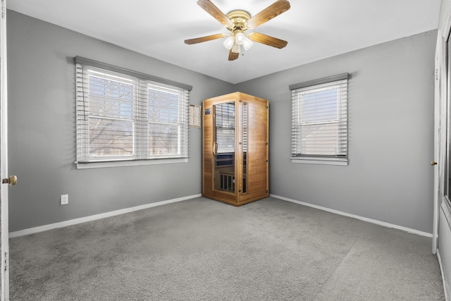 unfurnished bedroom featuring carpet, a ceiling fan, and baseboards