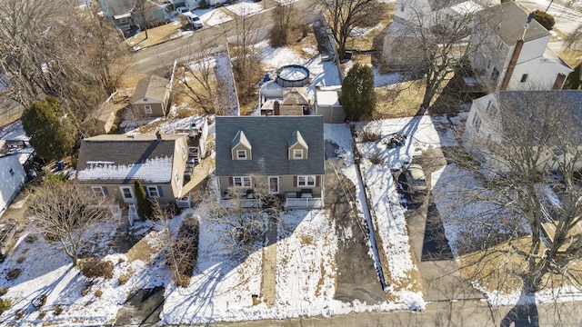 snowy aerial view with a residential view