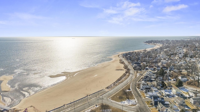 birds eye view of property with a water view and a view of the beach