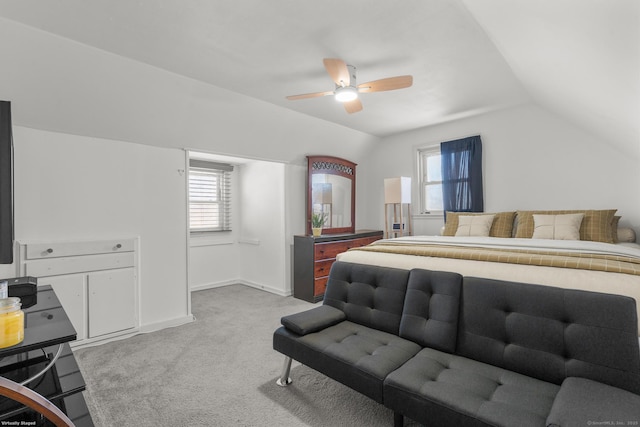 bedroom featuring a ceiling fan, light carpet, vaulted ceiling, and baseboards