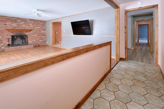 hallway with a textured ceiling and baseboards