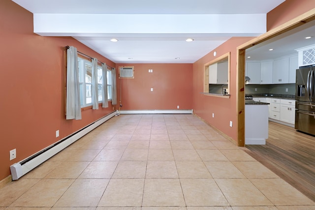 empty room with light tile patterned floors, a baseboard heating unit, beam ceiling, and recessed lighting