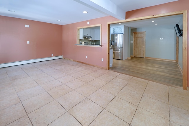 empty room featuring a baseboard radiator, recessed lighting, light tile patterned flooring, a sink, and baseboards