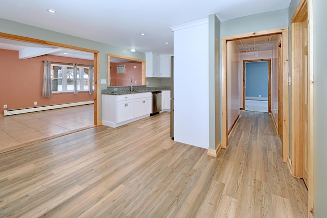 kitchen with a baseboard radiator, light wood-style flooring, stainless steel dishwasher, white cabinets, and a sink