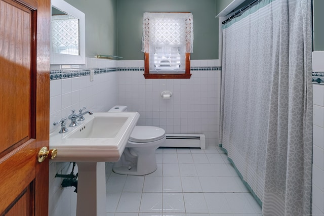 full bathroom featuring a healthy amount of sunlight, toilet, baseboard heating, and tile patterned floors