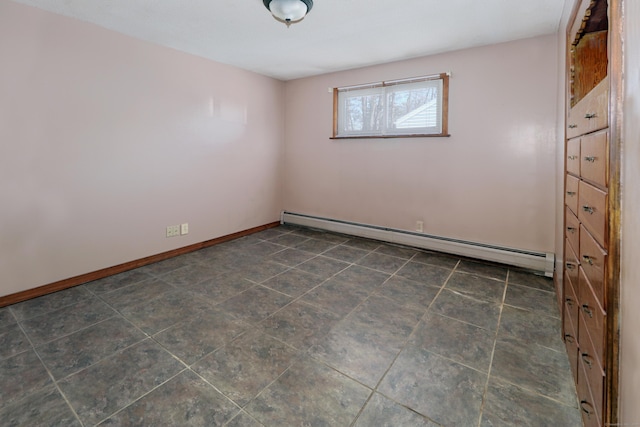 unfurnished room with a baseboard radiator and baseboards