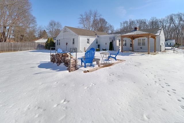 snow covered property featuring fence