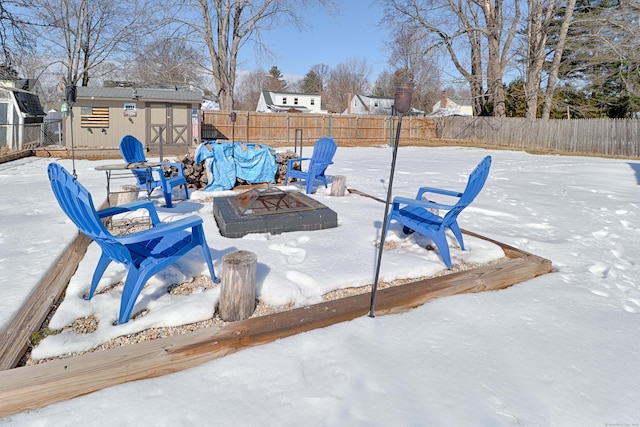 exterior space featuring a fire pit, an outdoor structure, and a fenced backyard