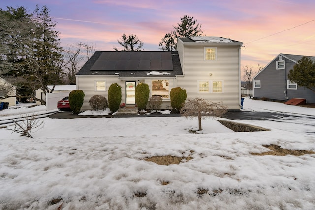 view of snow covered back of property