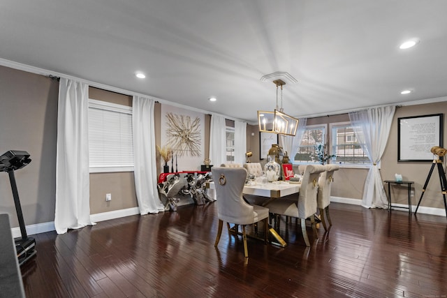 dining area featuring dark wood-style floors, baseboards, ornamental molding, and a chandelier