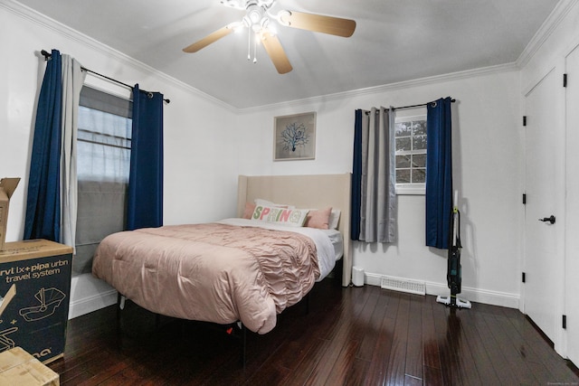 bedroom featuring dark wood-style floors, ceiling fan, baseboards, and crown molding