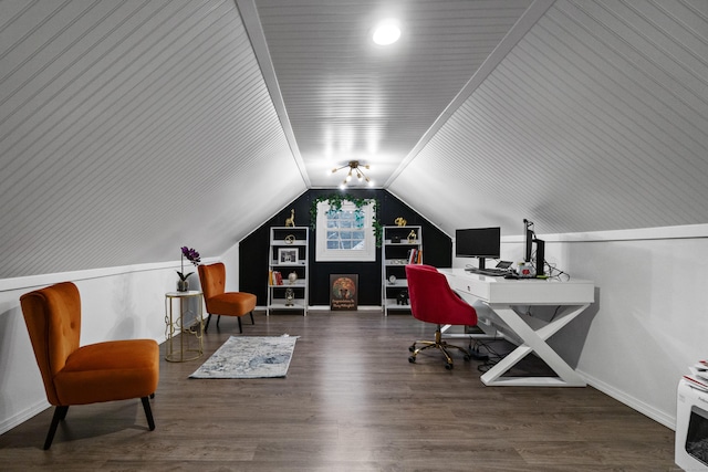 home office featuring lofted ceiling, built in shelves, baseboards, and wood finished floors