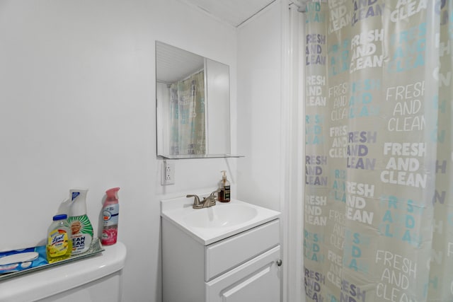 bathroom with a shower, vanity, and toilet