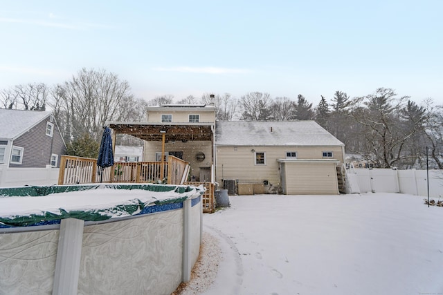 back of property featuring central air condition unit and fence