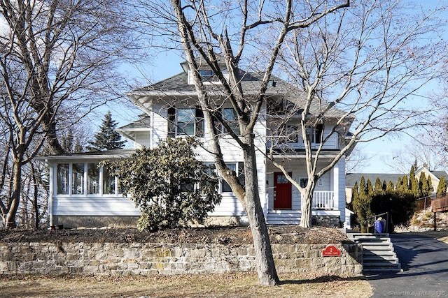 traditional style home with a sunroom and a balcony