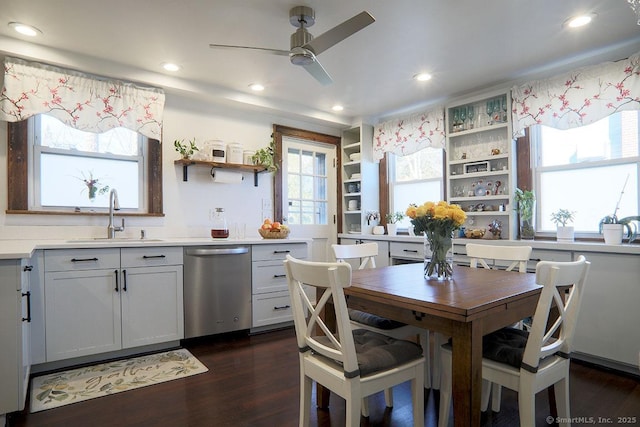 kitchen with dark wood-type flooring, a sink, light countertops, dishwasher, and open shelves