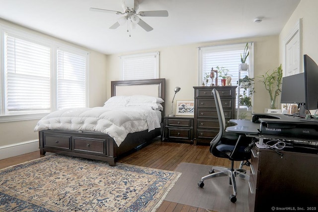 bedroom with a ceiling fan, baseboards, and wood finished floors