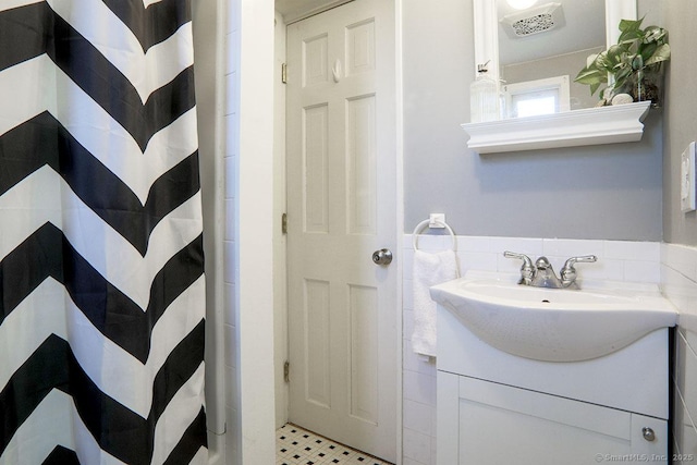 full bath featuring curtained shower, vanity, and tile patterned floors