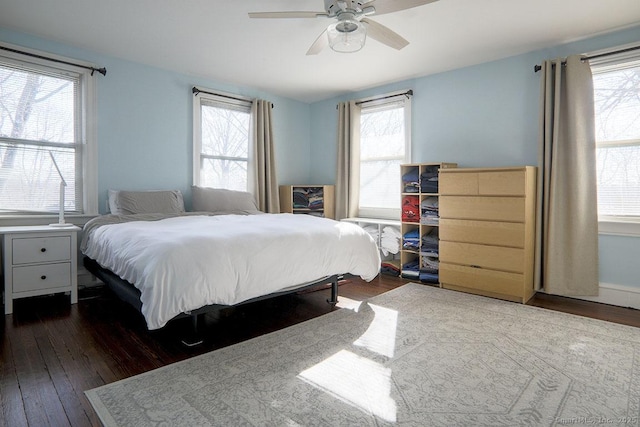 bedroom with dark wood-style floors and a ceiling fan