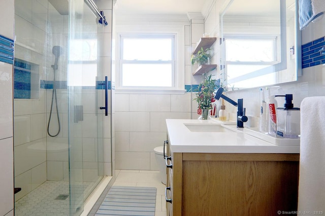 full bathroom with ornamental molding, plenty of natural light, and a shower stall