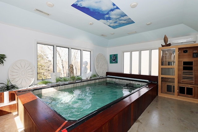 view of pool featuring a wall unit AC and an indoor hot tub