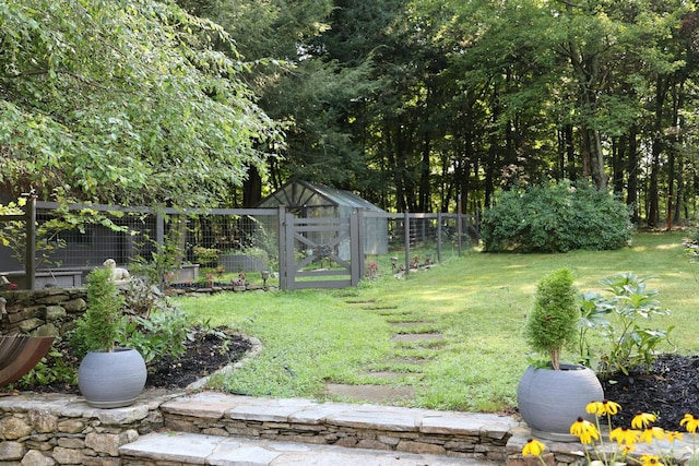 view of yard with fence and an outdoor structure