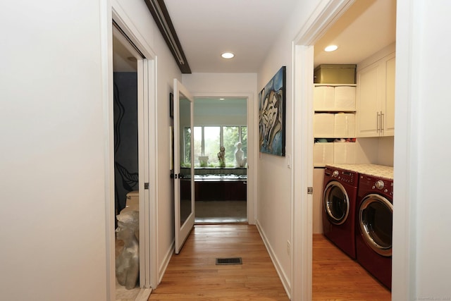 laundry room featuring recessed lighting, visible vents, washer and dryer, cabinet space, and light wood finished floors