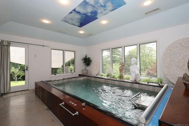 interior space with concrete flooring, recessed lighting, visible vents, and a hot tub