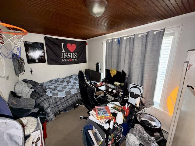 bedroom featuring a baseboard heating unit, wood ceiling, multiple windows, and carpet flooring