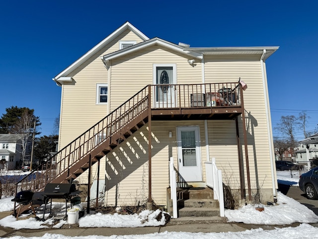 snow covered house with entry steps and stairs