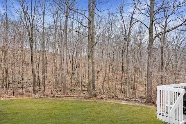 view of yard with a view of trees