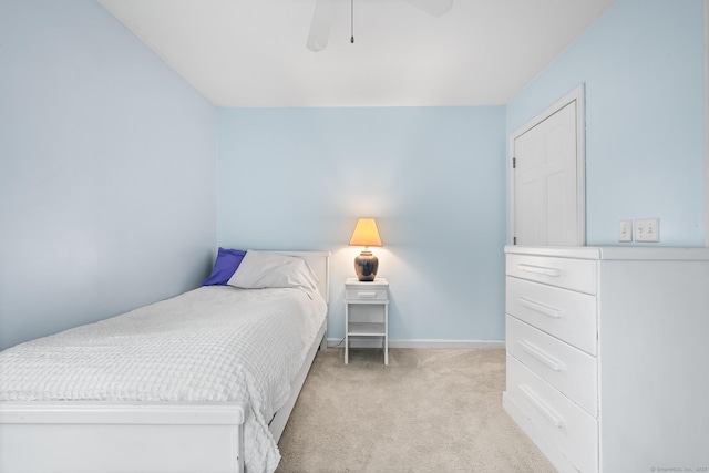 bedroom featuring light carpet, baseboards, and a ceiling fan