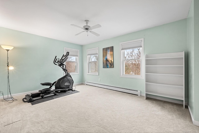 workout room with carpet floors, a baseboard radiator, baseboards, and a ceiling fan