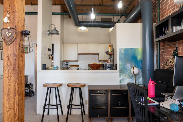 kitchen with a towering ceiling and white cabinets