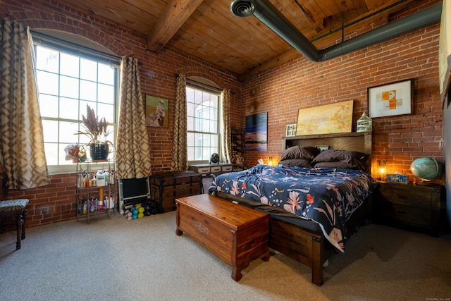 carpeted bedroom featuring beam ceiling, wooden ceiling, and brick wall