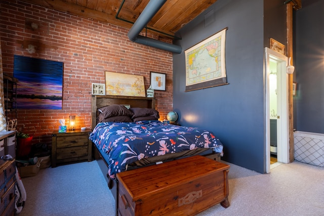 bedroom with brick wall, wooden ceiling, and carpet