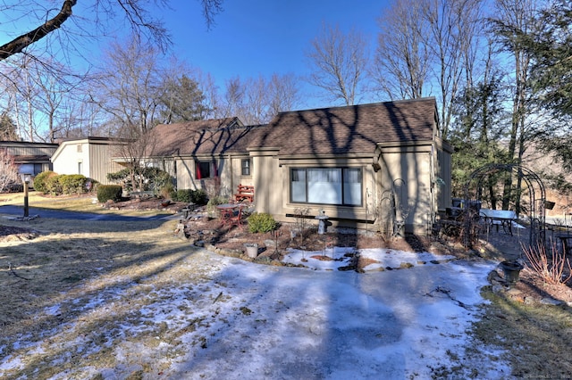 view of front of property featuring roof with shingles